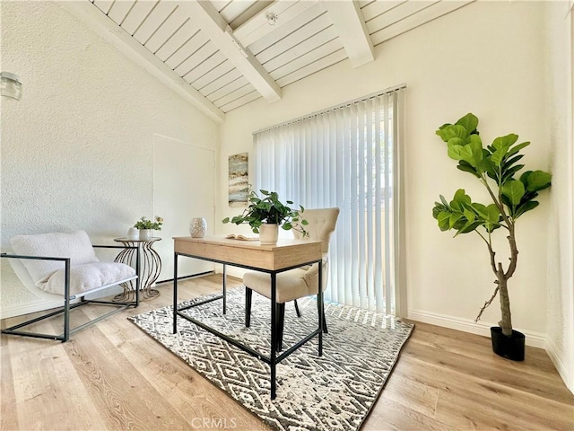 home office featuring vaulted ceiling with beams, wood finished floors, and baseboards