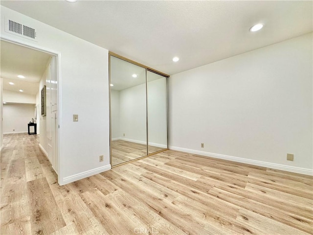 unfurnished bedroom with visible vents, light wood-style flooring, and recessed lighting