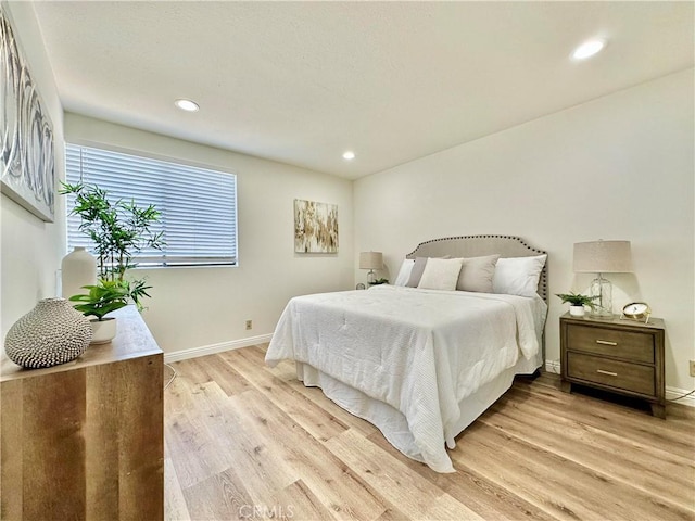 bedroom featuring baseboards, recessed lighting, and light wood finished floors