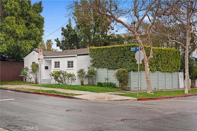 7116 Waring Ave, Los Angeles, CA 90046 - view of front facade with stucco siding and fence