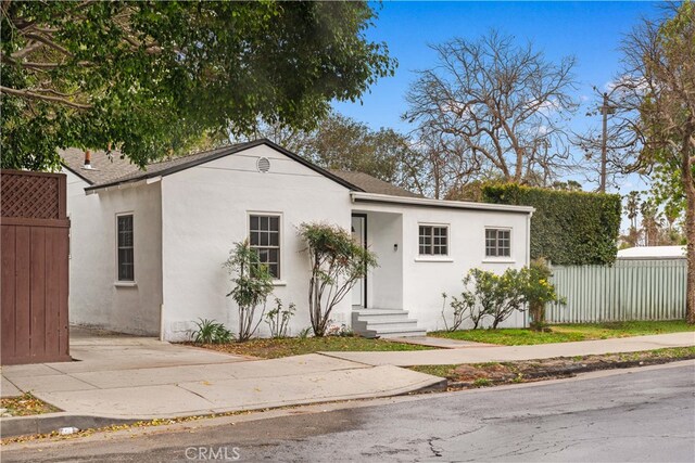 7116 Waring Ave, Los Angeles, CA 90046 - view of front of home featuring stucco siding, entry steps, and fence