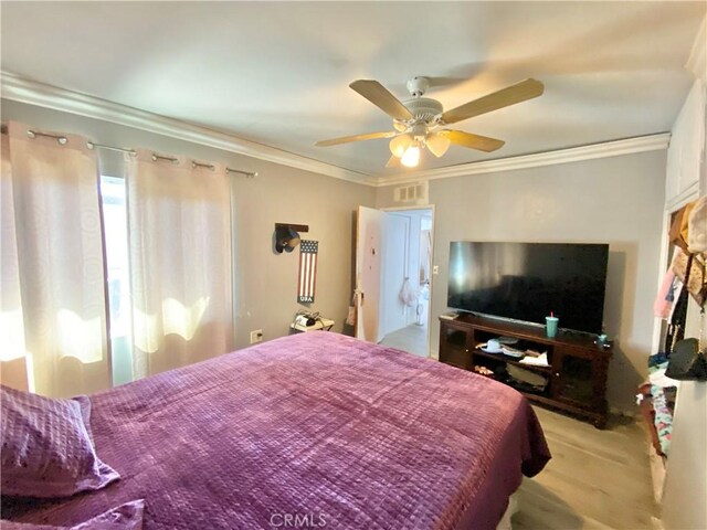 bedroom featuring visible vents, ornamental molding, and a ceiling fan