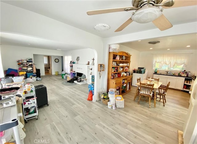 dining space featuring a ceiling fan and light wood finished floors