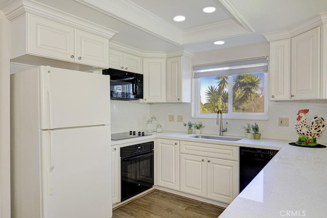 5 Via Castilla Unit B, Laguna Woods, CA 92637 - kitchen featuring black appliances, recessed lighting, a raised ceiling, wood finished floors, and ornamental molding