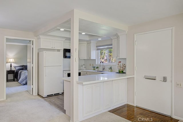 5 Via Castilla Unit B, Laguna Woods, CA 92637 - kitchen with freestanding refrigerator, black microwave, light countertops, a peninsula, and recessed lighting
