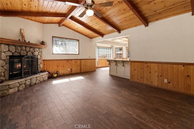 252 Riverside Ave, Sugarloaf, CA 92386 - unfurnished living room with wainscoting, wooden ceiling, a stone fireplace, vaulted ceiling with beams, and wood finished floors