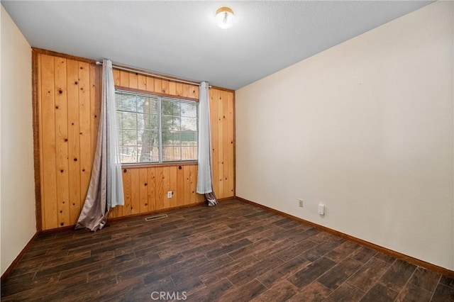 252 Riverside Ave, Sugarloaf, CA 92386 - empty room featuring dark wood-style floors, wooden walls, and baseboards