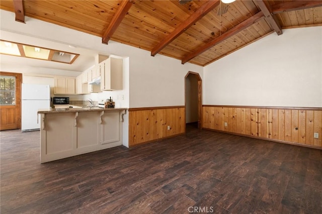 252 Riverside Ave, Sugarloaf, CA 92386 - kitchen with a wainscoted wall, vaulted ceiling with beams, a sink, and freestanding refrigerator