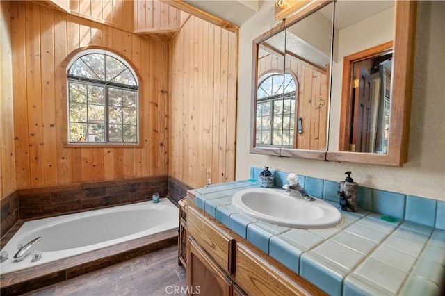 252 Riverside Ave, Sugarloaf, CA 92386 - bathroom featuring vanity, a healthy amount of sunlight, wooden walls, and a bath