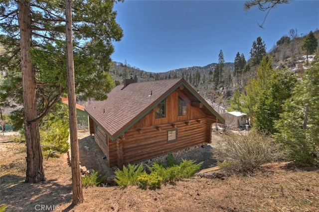29632 Hook Creek Rd, Cedar Glen, CA 92321 - view of side of home with log exterior, a chimney, and a mountain view