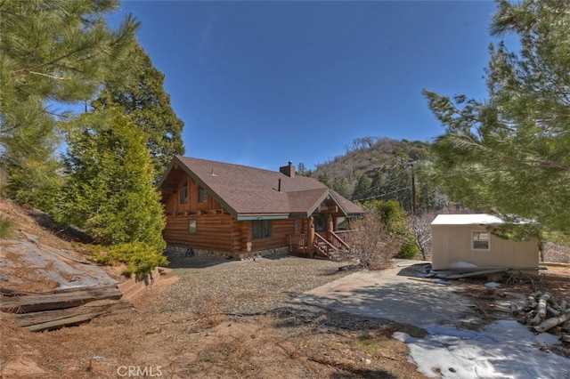 29632 Hook Creek Rd, Cedar Glen, CA 92321 - view of home's exterior featuring a chimney, an outbuilding, log exterior, and a mountain view