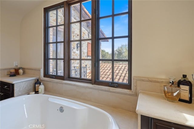 full bathroom featuring a tub to relax in and plenty of natural light