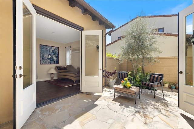 view of patio / terrace featuring french doors and fence