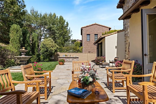 view of patio / terrace with an outdoor living space and fence