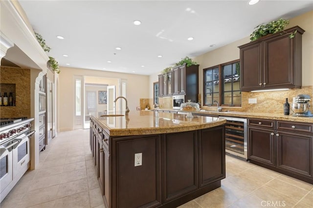 3 Observatory, Newport Coast, CA 92657 - kitchen featuring wine cooler, range with two ovens, backsplash, a sink, and recessed lighting