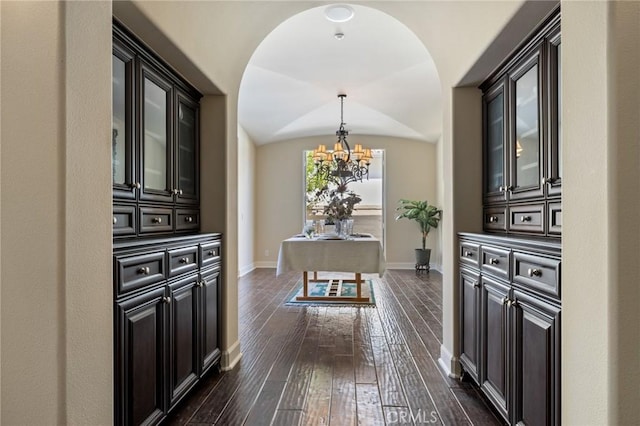 3 Observatory, Newport Coast, CA 92657 - hall featuring a chandelier, baseboards, dark wood-type flooring, and lofted ceiling