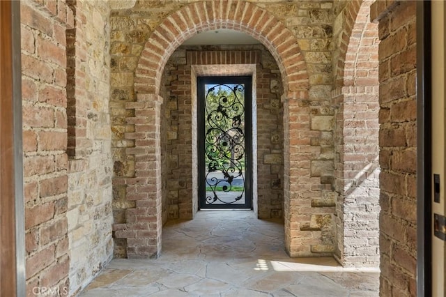 property entrance featuring brick siding