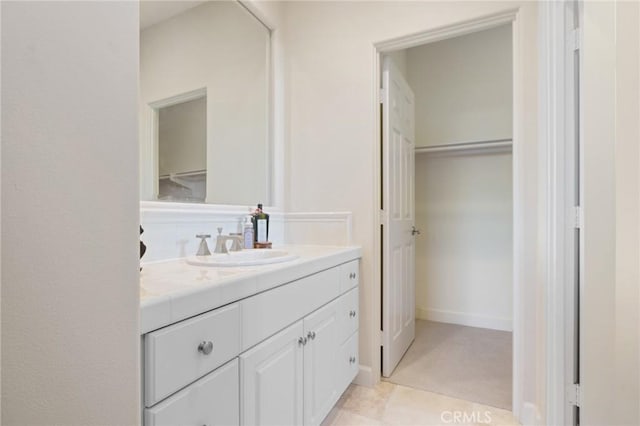 bathroom featuring vanity and a spacious closet