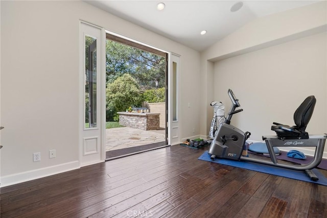 exercise room featuring recessed lighting, lofted ceiling, hardwood / wood-style floors, and baseboards