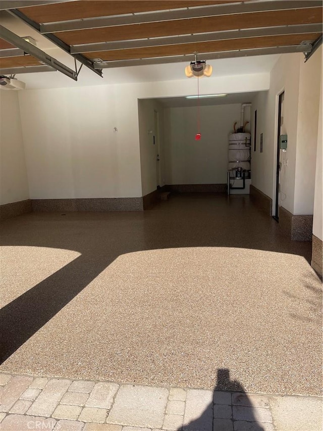 garage with baseboards and a garage door opener
