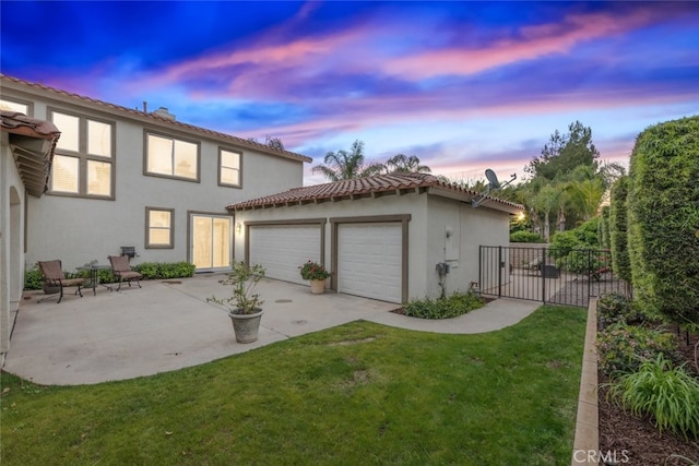 2845 Keystone Cir, Corona, CA 92882 - rear view of house with stucco siding, an attached garage, concrete driveway, a tile roof, and a patio area