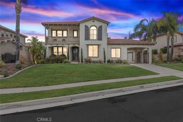 2845 Keystone Cir, Corona, CA 92882 - mediterranean / spanish-style house featuring a balcony, a tile roof, stucco siding, concrete driveway, and a gate