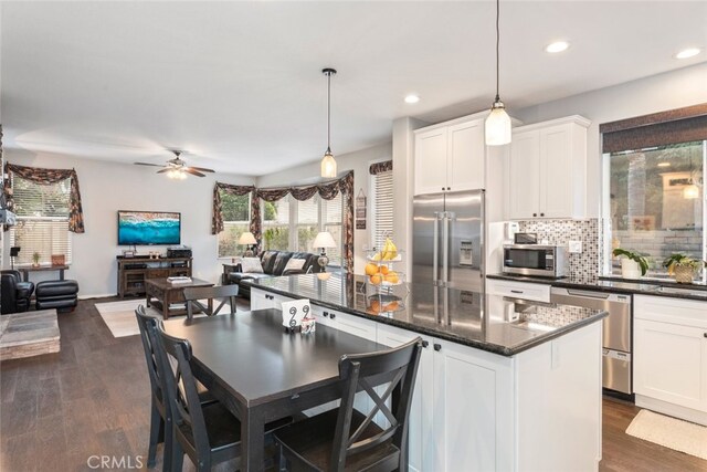 2845 Keystone Cir, Corona, CA 92882 - kitchen featuring appliances with stainless steel finishes, open floor plan, tasteful backsplash, dark wood-style floors, and white cabinetry