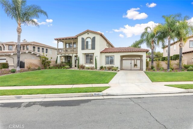 2845 Keystone Cir, Corona, CA 92882 - mediterranean / spanish-style house with a balcony, an attached garage, driveway, stucco siding, and a tile roof