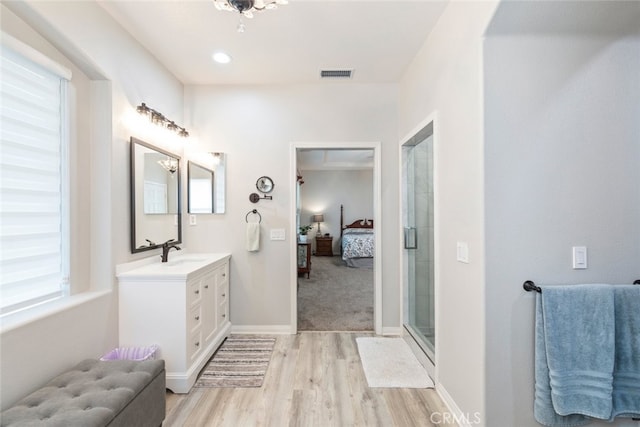 2845 Keystone Cir, Corona, CA 92882 - bathroom featuring connected bathroom, vanity, wood finished floors, an enclosed shower, and a chandelier