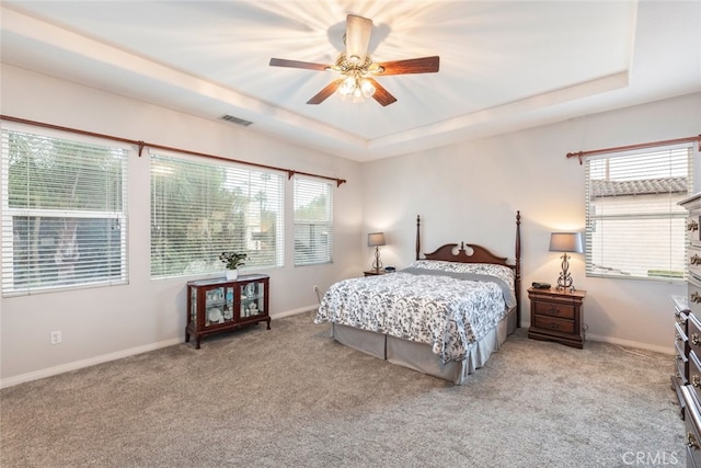 2845 Keystone Cir, Corona, CA 92882 - carpeted bedroom featuring a raised ceiling, baseboards, and a ceiling fan