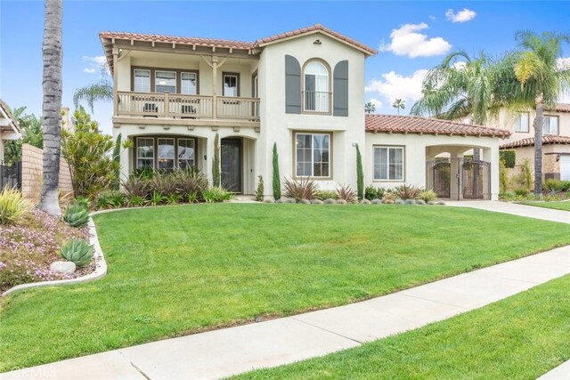 2845 Keystone Cir, Corona, CA 92882 - mediterranean / spanish-style home featuring a balcony, stucco siding, a tile roof, and a front yard