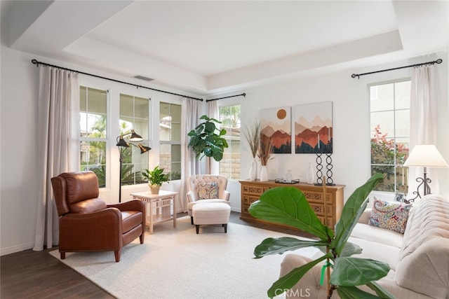 2845 Keystone Cir, Corona, CA 92882 - living area with a tray ceiling, wood finished floors, and baseboards