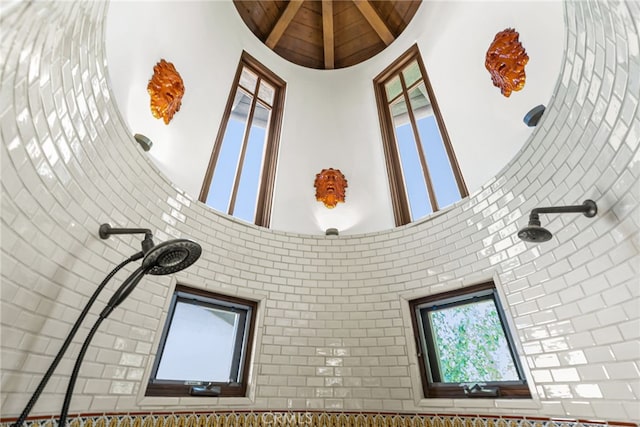 room details with wooden ceiling and tiled shower
