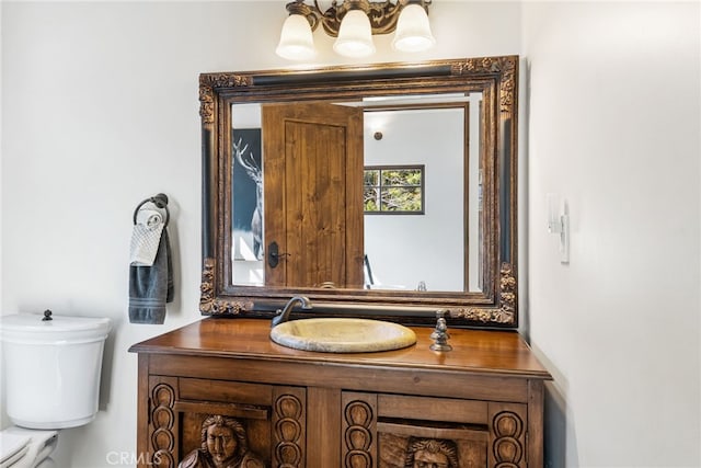 bathroom with toilet and vanity