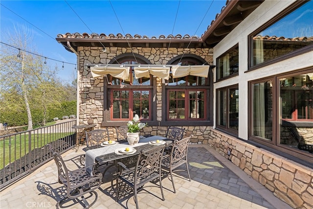 view of patio featuring outdoor dining area and fence