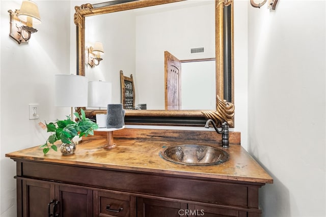 bathroom featuring visible vents and vanity