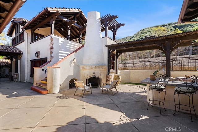 view of patio featuring a pergola, stairs, and outdoor dry bar