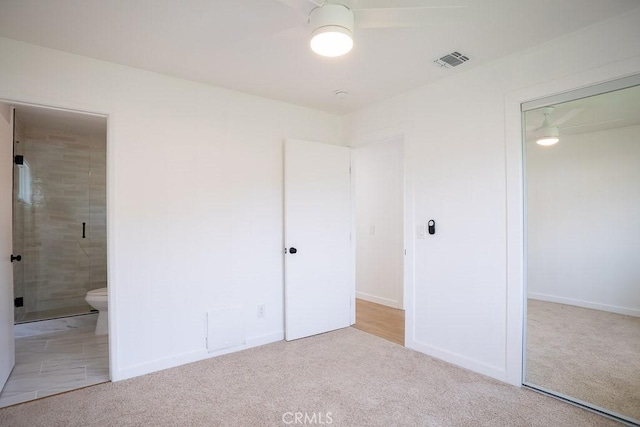 unfurnished bedroom with a closet, carpet flooring, and visible vents