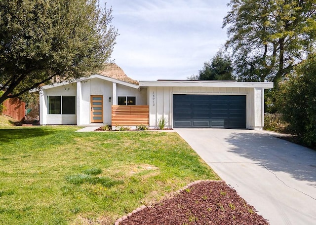 mid-century inspired home with an attached garage, board and batten siding, driveway, and a front yard