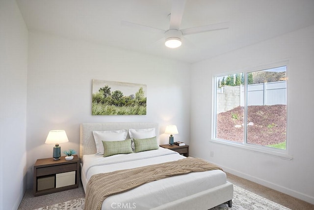 bedroom with carpet flooring, baseboards, and a ceiling fan