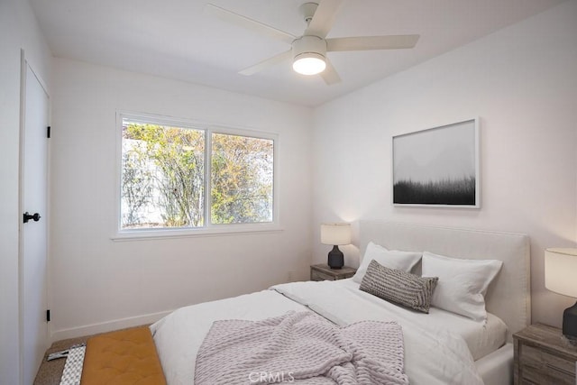 bedroom with baseboards and ceiling fan