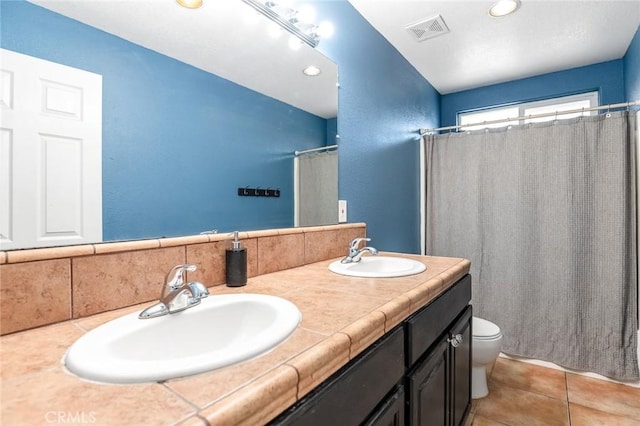 full bath featuring tile patterned flooring, toilet, visible vents, and a sink
