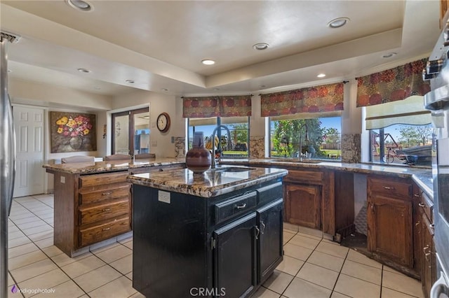 6351 Deacon Ave, Bakersfield, CA 93307 - kitchen with a kitchen island, a raised ceiling, and a sink