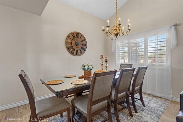 6351 Deacon Ave, Bakersfield, CA 93307 - dining room with light wood finished floors, a notable chandelier, baseboards, and vaulted ceiling