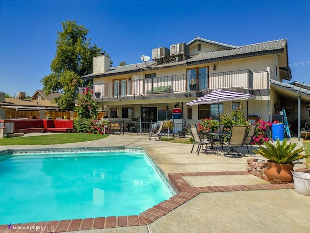 6351 Deacon Ave, Bakersfield, CA 93307 - back of house with a patio area, a fenced in pool, a chimney, and a balcony