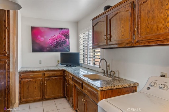 6351 Deacon Ave, Bakersfield, CA 93307 - kitchen with a sink, washer / clothes dryer, light tile patterned flooring, and brown cabinetry