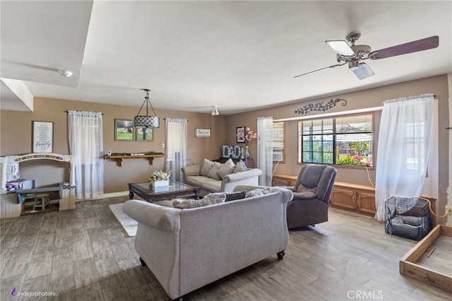 6351 Deacon Ave, Bakersfield, CA 93307 - living area featuring a ceiling fan, wood finished floors, and baseboards