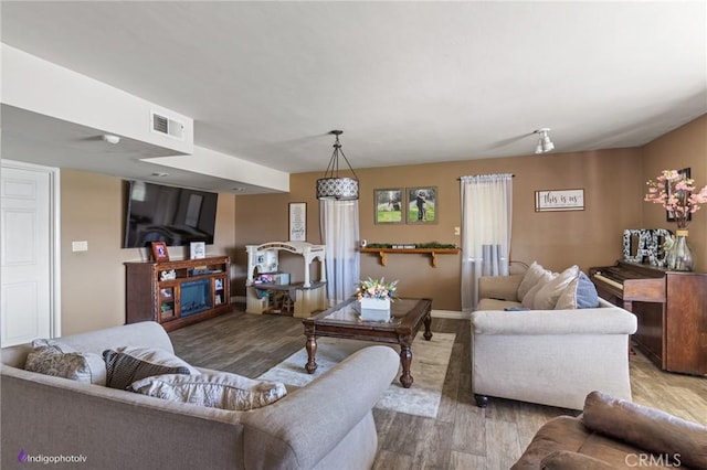 6351 Deacon Ave, Bakersfield, CA 93307 - living area featuring visible vents, baseboards, and wood finished floors