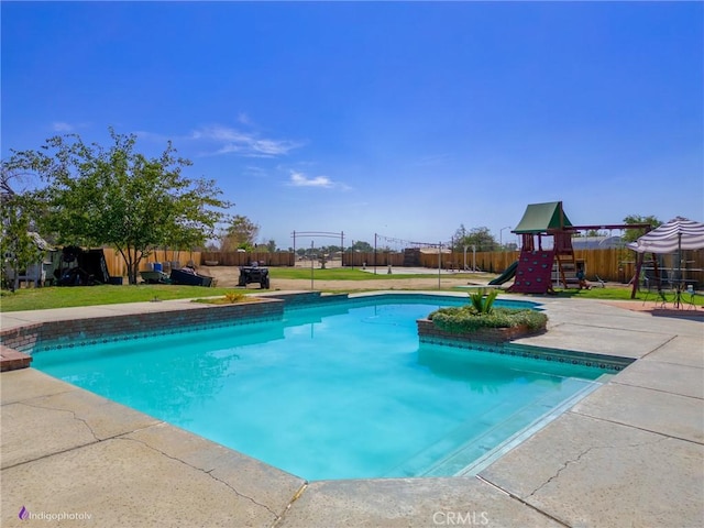6351 Deacon Ave, Bakersfield, CA 93307 - view of pool with a playground, a fenced backyard, a fenced in pool, and a lawn