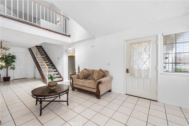 42851 Lemonwood Dr, Lancaster, CA 93536 - living area featuring stairway, light tile patterned floors, and high vaulted ceiling